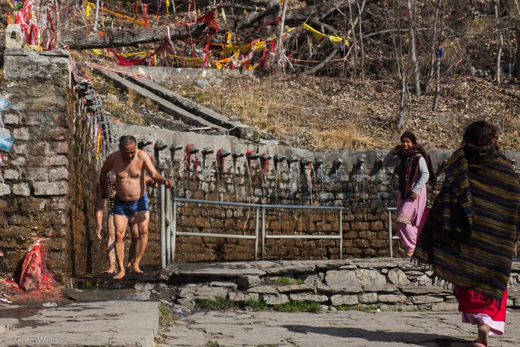 Men running through the 108 waterspouts at Muktinath